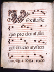 Large black initial with red highlighting. Four lines of text and four of music