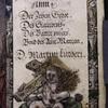 Title page, with names of works by Martin Luther, and woodcut?  Figured border