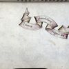 Title page with title set into a scroll