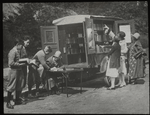 Readers choosing books and checking them out, ca. 1920s