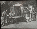 Readers choosing books and checking them out, ca. 1920s