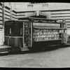 Book truck at 40th street entrance of N.Y.P.L. Central building, ca. 1930s, showing it open for display.