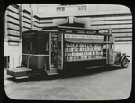 Book truck at 40th street entrance of N.Y.P.L. Central building, ca. 1930s, showing it open for display