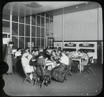 Young women around tables reading, P.S. 63, Recreation Center, May 1911