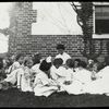 Work with schools, High Bridge : Miss Luella F. Magill reading fairy story outdoors, in July, 1912.
