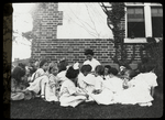 Work with schools, High Bridge : Miss Luella F. Magill reading fairy story outdoors, in July, 1912