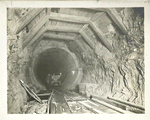 Rondout pressure tunnel. Completed excavation with temporary roof timbering in place. Finished concrete lining in background. Contract 12. April 21, 1911.