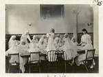 A group of girls making surgical dressings.