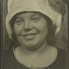 Smiling, Slavic-looking woman in white cloth cap