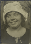 Smiling, Slavic-looking woman in white cloth cap