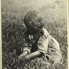 Young girl picking some kind of herb