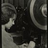 Woman operating some kind of press