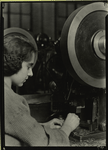 Woman operating some kind of press