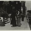 Entrance to a millinery supplies firm, showing several women on sidewalk, horse-cab and child playing in the trash][another copy]