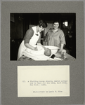 A visiting nurse showing Jewish mother how to care for the baby, East Side, New York, 1925