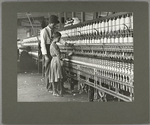 The mill superintendant teaching one of  the young spinners, December 1908