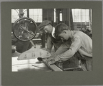 An apprentice working at a properly safeguarded "buzz saw," 1915