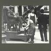 ... this bootblack keeps his mind on his job, July 1910