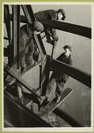 Three men welding an iron beam, high above the city