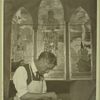 Glazer cutting pieces for a stain-glass window like those in the background