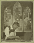Glazer cutting pieces for a stain-glass window like those in the background