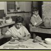 Two young boys learning the potter's trade