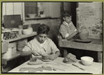 Two young boys learning the potter's trade