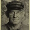Workman with glasses and visored cap