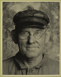 Workman with glasses and visored cap