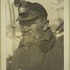 Miner in overcoat with cap and light.