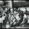 Work with schools, Hudson Park Branch : men look on as children are read to in the park, ca. 1910