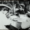 Work with schools : writing a composition : girls each wearing straw hat, bent over their work, ca. 1910s