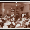 Work with schools : children's room : children at tables and choosing books from shelves, ca. 1920