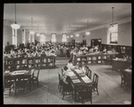 Work with schools : class visit, showing one half of large room packed with children, ca. 1920?
