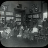Work with schools : Dan Beard telling a story to a group of boys and girls in the Flatbush Library (L.I.) in 1913