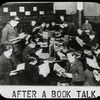 Work with schools : after a book talk, showing boys gathered around table reading, ca. 1920s