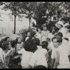 Work with schools : story hour in the open, librarian and children in park, ca. 1920s