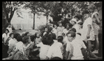 Work with schools : story hour in the open, librarian and children in park, ca. 1920s