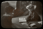 Work with schools : a 'private' lesson, child showing something in book to librarian, ca. 1920?