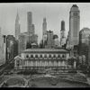 Central building, exterior views : Bryant Park facade from above Bryant Park, park in foreground, tall buildings visible beyond, including Chrysler building and building under construction, ca. 1930s.