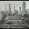Central building, exterior views : Bryant Park facade from above Bryant Park, park in foreground, tall buildings visible beyond, including Chrysler building and building under construction, ca. 1930s