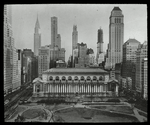 Central building, exterior views : Bryant Park facade from above Bryant Park, park in foreground, tall buildings visible beyond, including Chrysler building and building under construction, ca. 1930s