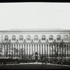 Central building, exterior views : Bryant Park facade from the park, fountain and Bryant Monument in center, people on benches, 1915