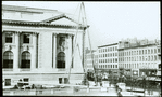 Central building, exterior views, Fifth Avenue : placing flagpole in position, north flagpole