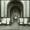 Central building, first floor lobby : looking from lobby (Astor Hall) toward exhibition hall, war posters (?) displayed on either side, ca. 1918