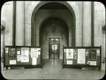 Central building, first floor lobby : looking from lobby (Astor Hall) toward exhibition hall, war posters (?) displayed on either side, ca. 1918