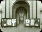 Central building, first floor lobby : looking from lobby (Astor Hall) toward exhibition hall, war posters (?) displayed on either side, ca. 1918