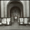 Central building, first floor lobby : looking from lobby (Astor Hall) toward exhibition hall, war posters (?) displayed on either side, ca. 1918