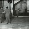 Central building, guards : the inspection at the door of visitor's books, parcels, etc.  Flannagan is the guard, Sept. 1913