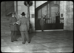 Central building, guards : the inspection at the door of visitor's books, parcels, etc.  Flannagan is the guard, Sept. 1913